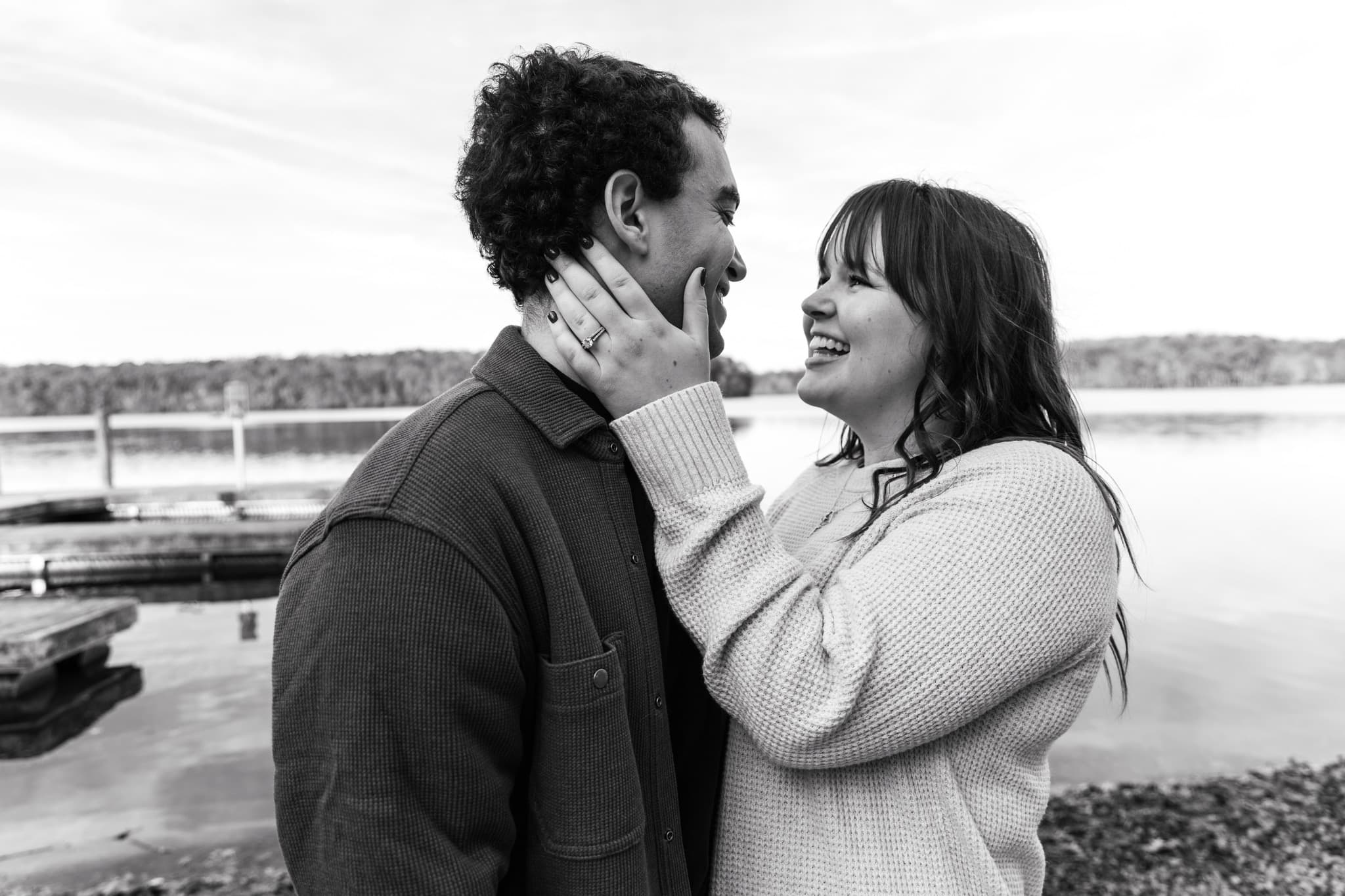 A newly engaged couple share a close embrace.