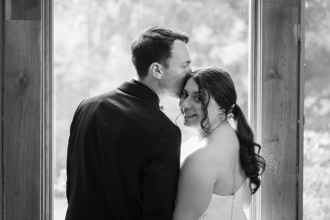 Picture of a newly wed couple in front of a window